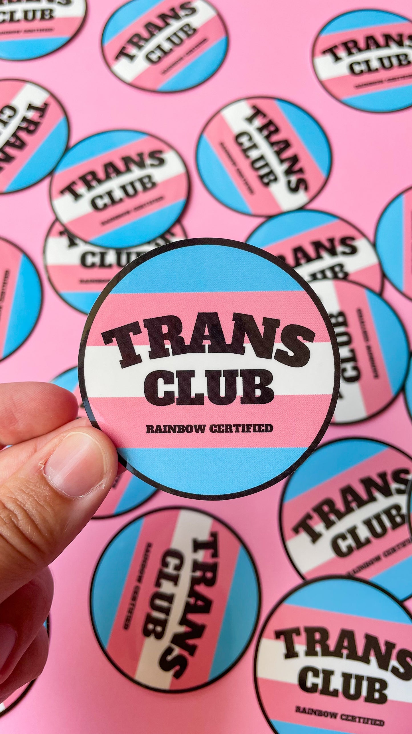 circle sticker that says trans club with Transgender pride flag
