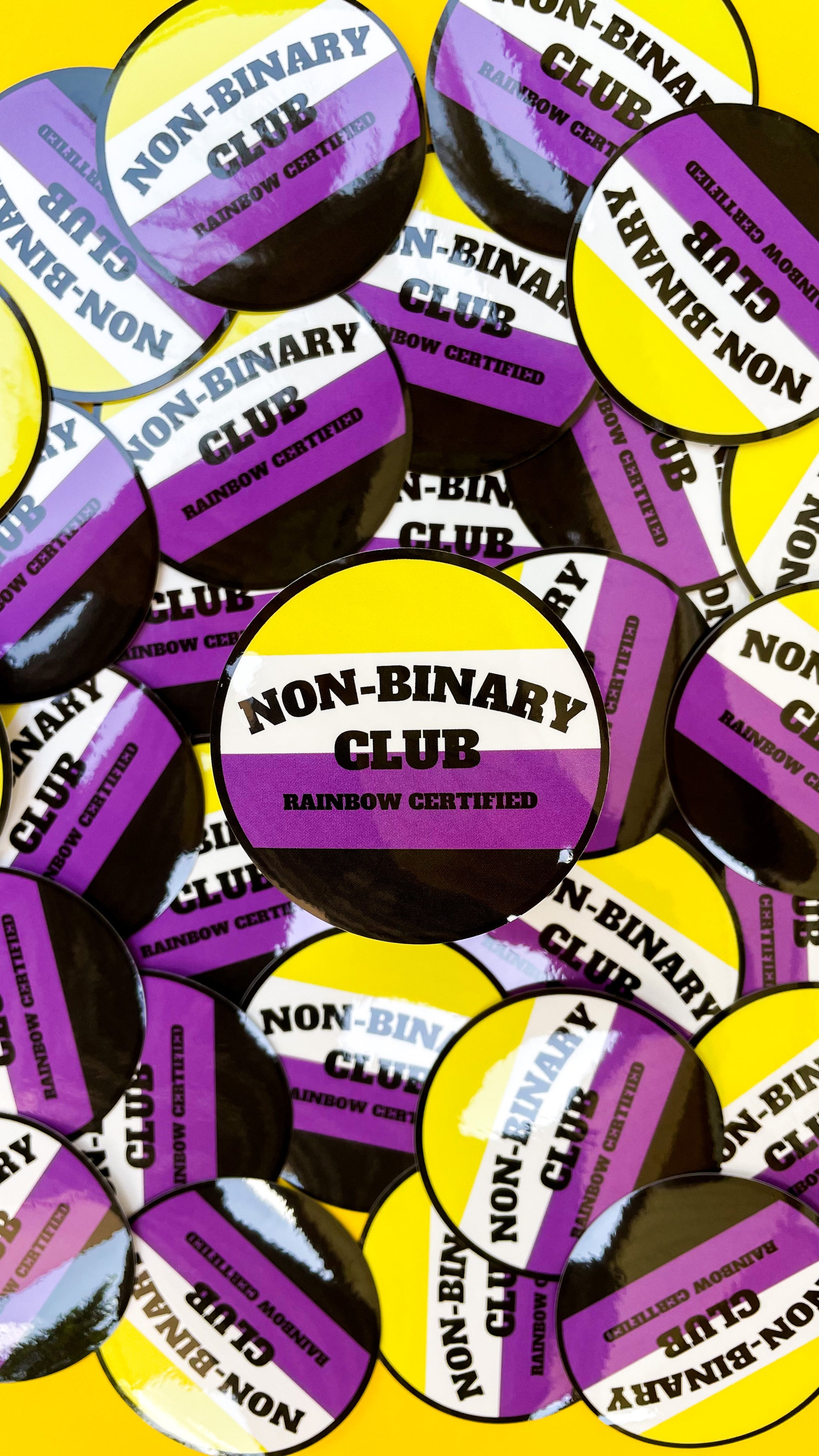 circle sticker that says non-binary club
