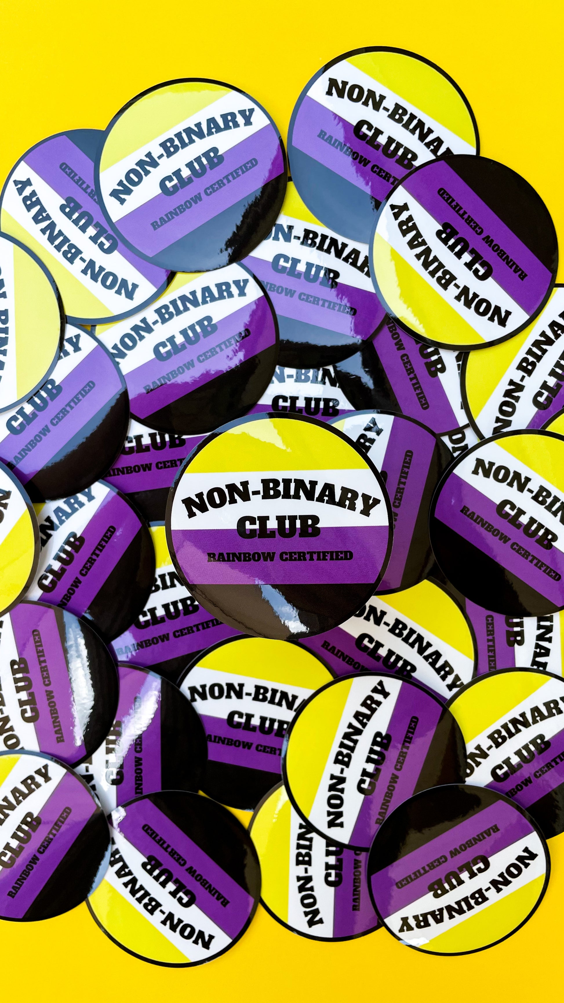 circle sticker that says non-binary club