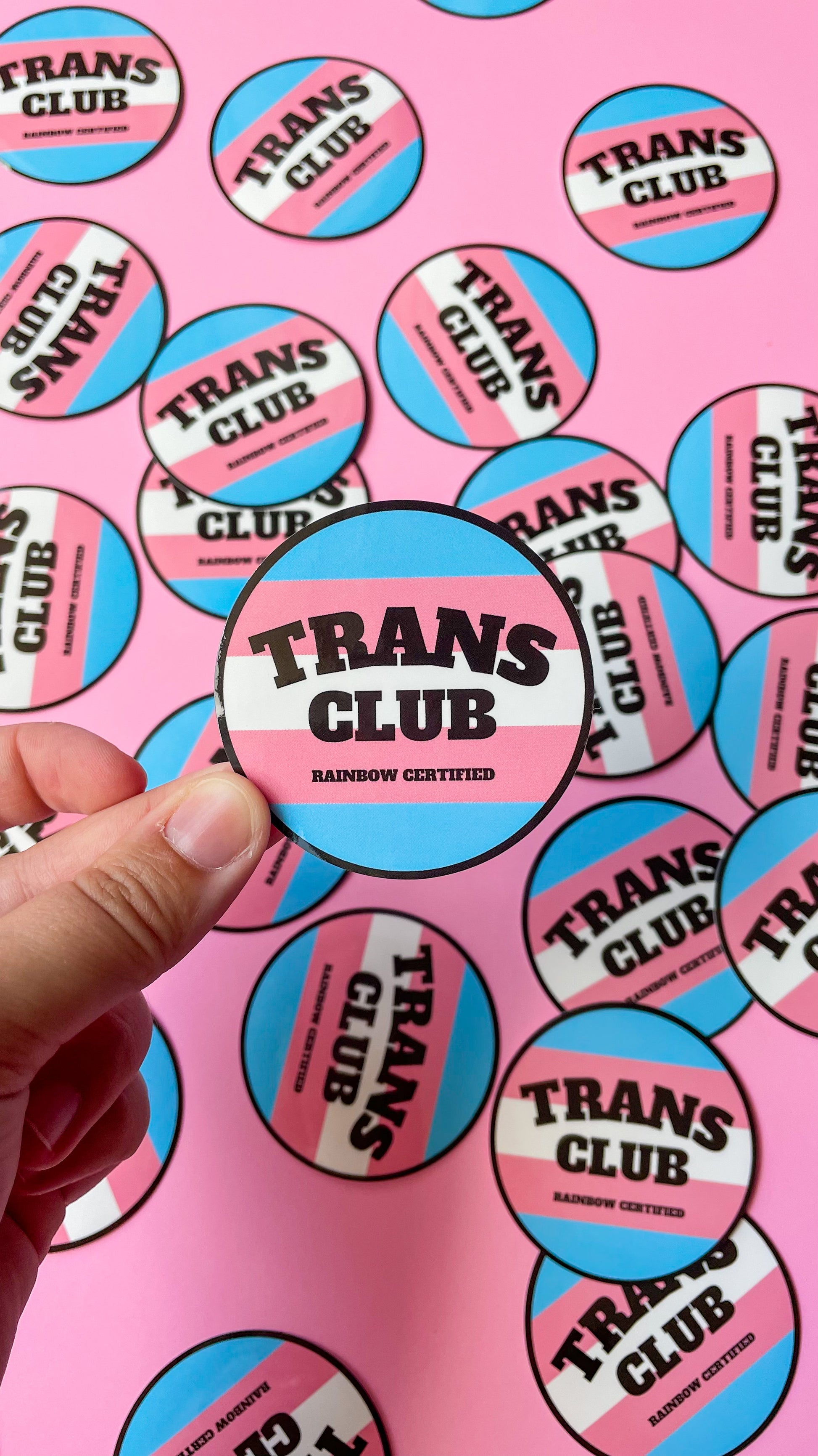 circle sticker that says trans club with Transgender pride flag