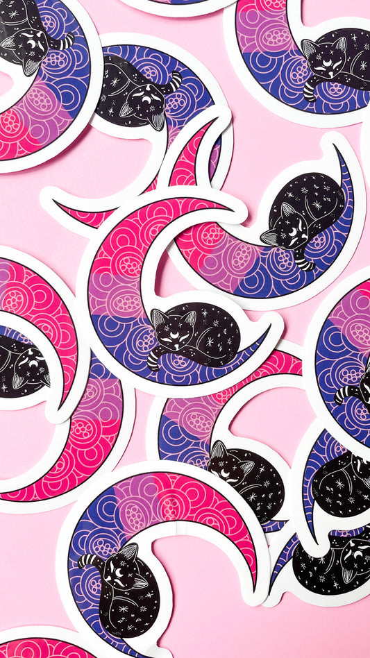 bisexual pride flag in the shape of a moon with cat sitting on it